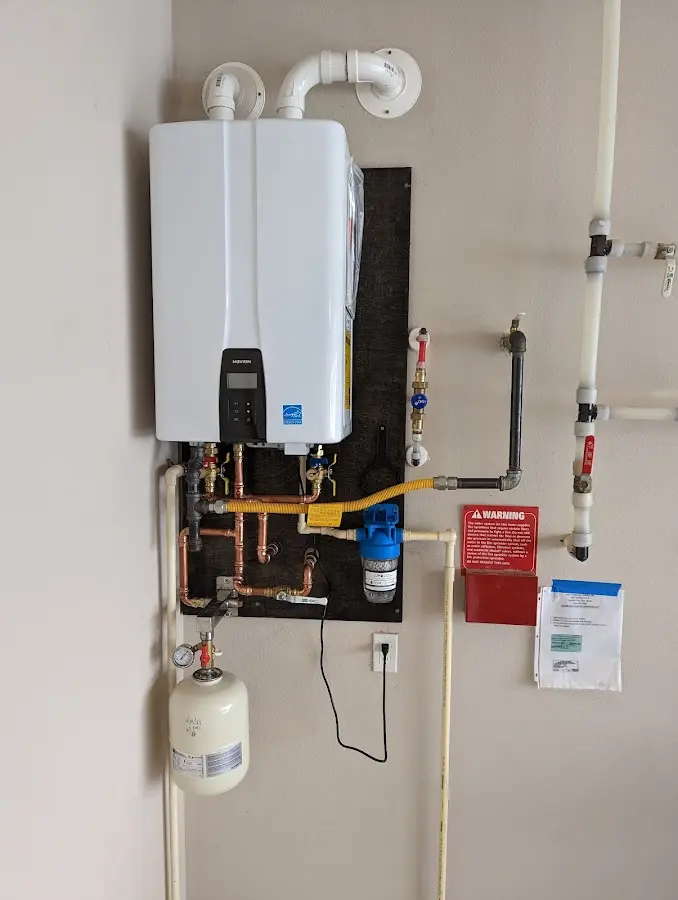 Professional plumber installing copper piping in a Hickam Housing home